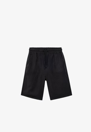 Shorts noirs en tissu doux, avec une taille élastique et un cordon de serrage, dotés de deux poches latérales et d'une coupe décontractée.