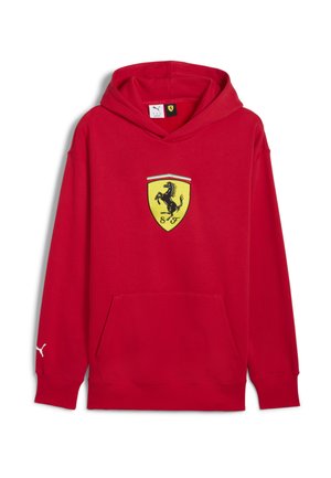 Haut en coton rouge avec une poche avant, comportant un logo Ferrari jaune avec un cheval cabré noir et des accents vert-blanc-rouge sur l'emblème.