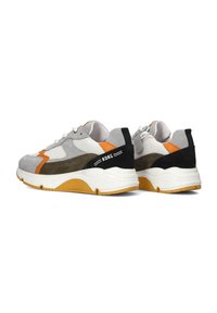 Grey and black suede sneakers with orange and white accents. Thick rubber sole with grooves, lace-up design, and branded detail on heel.