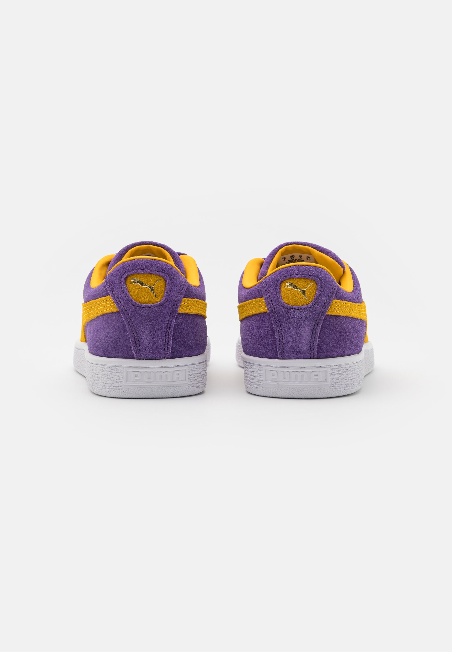 purple and yellow puma suedes