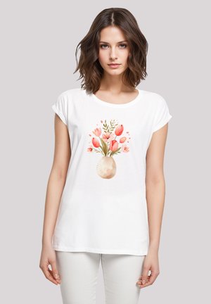 White short-sleeve t-shirt featuring a watercolor floral design with pink tulips in a light vase. Soft fabric and relaxed fit.
