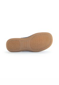 Brown rubber sole with textured grip patterns. Features brand logo and size detail. Underneath is smooth with rounded edges.