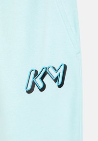 Nike Sportswear KYLIAN MBAPPÉ CLUB UNISEX - Teplákové kalhoty - glacier blue
