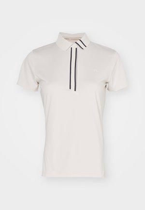 Ανοιχτό μπεζ πόλο μπλουζάκι με γιακά, με δύο κάθετες ναυτικές ρίγες, κοντά μανίκια και ένα μικρό λογότυπο στο στήθος. Μαλακό υφασματικό υλικό.