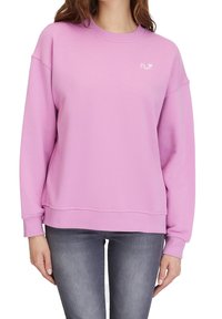 Růžová mikina z měkké látky s kulatým výstřihem, sklopenými rameny a žebrovanými manžetami. Malé logo na hrudi, volný střih.