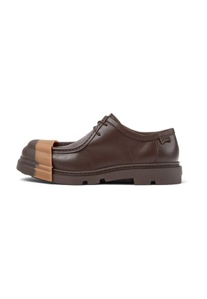 Brown leather shoe with a rounded shape, rubber toe cap, and thick sole. Features lace-up design and minimal accents. Smooth texture.