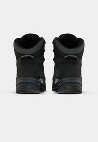 Zwarte wandelschoenen met een gevoerde grijze kraag en metalen hardware. Beschikt over een geprofileerde zool en een verstevigde hak voor duurzaamheid.