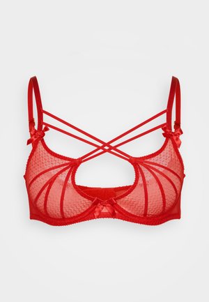 Soutien-gorge en dentelle rouge avec un motif géométrique, présentant des bonnets transparents, des bretelles croisées dans le dos, et des nœuds en satin sur les bretelles pour plus de détails.