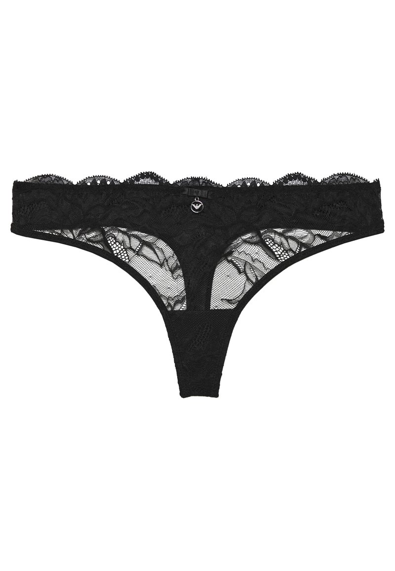 Zwarte kanten slip met golvende randen, bloemmotieven en doorschijnende meshpanelen. Bevat een klein centraal accentdetail. Zachte textuur.
