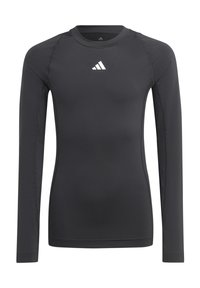 T-shirt de sport noir à manches longues en tissu lisse et extensible, avec un logo blanc sur la poitrine et des coutures plates.