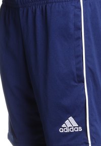 Navy blue athletic shorts made of lightweight fabric, featuring white side stripes and an Adidas logo on the left hem.