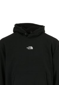 Felpa nera con cappuccio in morbido cotone, dotata di una tasca frontale. Presenta un piccolo logo bianco di "The North Face" sul petto.