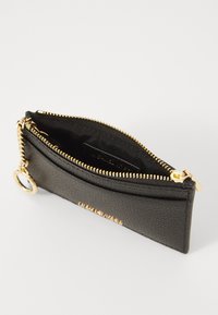 Black leather wallet with a textured finish, gold zipper, and chain. Features an outer compartment and a smooth interior lining.