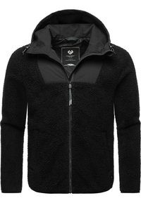 Giacca in pile nera con uno strato esterno testurizzato e pannelli in tessuto nero liscio. Presenta una chiusura con zip e un cappuccio regolabile.
