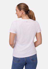 Witte katoenen t-shirt met korte mouwen, ronde halslijn, zachte textuur, met een klein logo op de rug nabij de kraag.