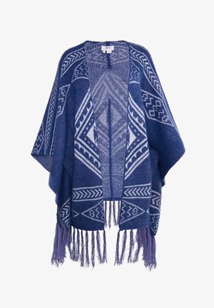 Poncho blu navy con motivi geometrici bianchi, caratterizzato da una vestibilità ampia, frontale aperto e orlo frangiato per una texture aggiuntiva.