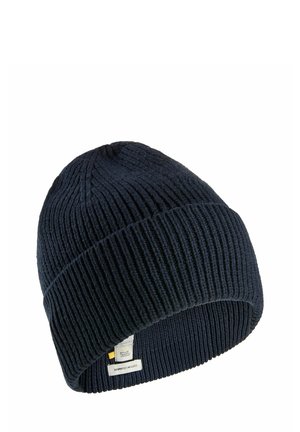 Navy knitted beanie hat with ribbed texture and a fold-over cuff. Features a label on the side with text and logo details.