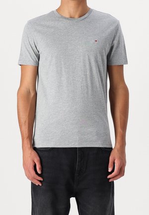 Gray cotton t-shirt with a crew neck and short sleeves. Features a small, multicolored logo on the left chest. Smooth texture.