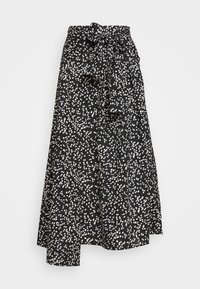 Svart kjol med vitt prickigt mönster, hög midja, knytning vid midjan och utsvängd nederdel. Mjukt, lätt material.