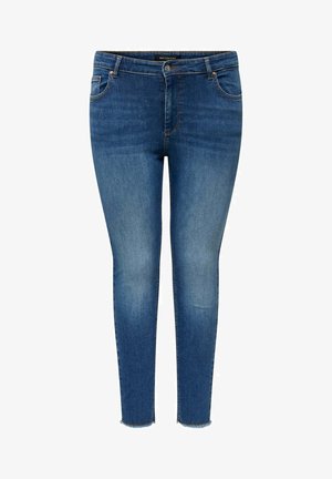 Kapeat farkut keskisiniset, viisi-taskumallilla, hienovaraisella haalistumisella ja rispaantuneella helmalla nilkassa lisäyksinä.