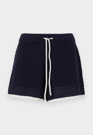 Marineblå strikkede shorts med et tekstureret mønster, justerbar snørrelukning og en scallop-hvid kant. Let og åndbart materiale.