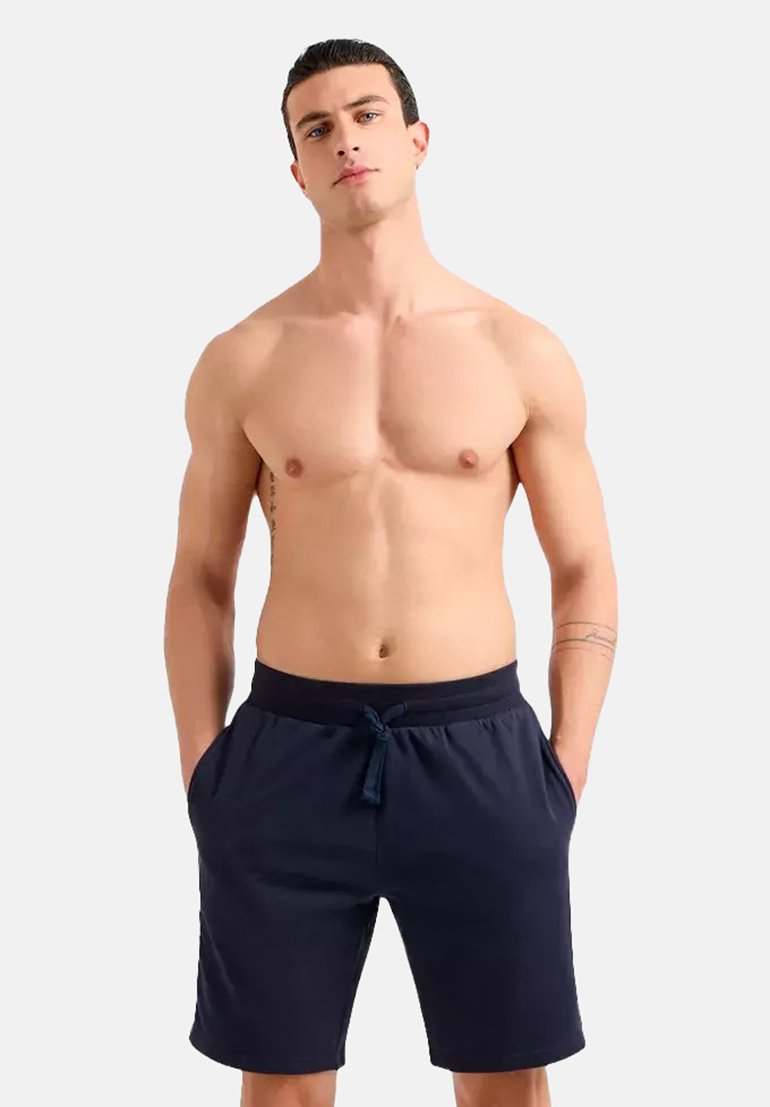 Shorts de sport bleu marine en tissu léger, dotés d'une taille élastique avec cordon de serrage et de poches latérales.