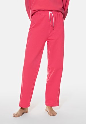 Pink sweatpants with a drawstring waistband, straight leg design, and soft fabric. Ends are finished with flat seams. No pockets.