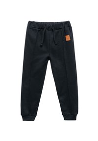 Pantalones de chándal negros de tejido suave, con una cinturilla elástica con cordón, puños acanalados y un pequeño parche de cuero marrón con el logo.