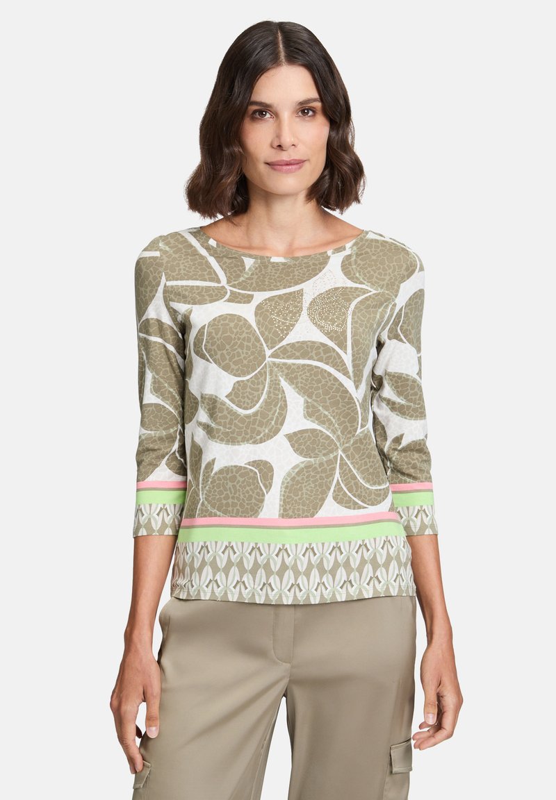 Green and white patterned long-sleeve top with a boat neckline. Features pink and green striped accents at the hem and sleeve cuffs.