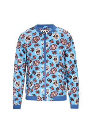 Blue bomber jacket with a zip front, featuring an all-over print of sugar skulls and floral designs in red, black, and ivory.