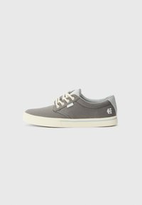 Gray canvas sneakers feature a round toe, light cream sole, and lace-up design with contrasting gray and white accents.
