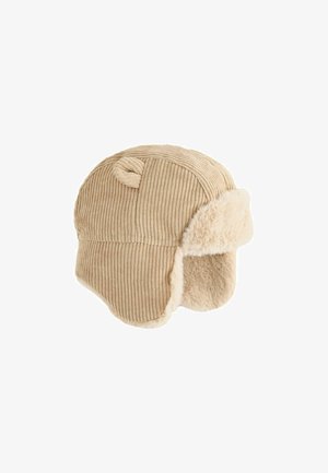 Beige kordfløjlsfælderhat med små stofører og blødt pelsfor på øreklapper og forreste skygge.
