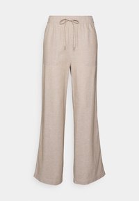 Beige vida byxor i ett mjukt, strukturerat tyg. Har en elastisk midja med dragsko och två framfickor.