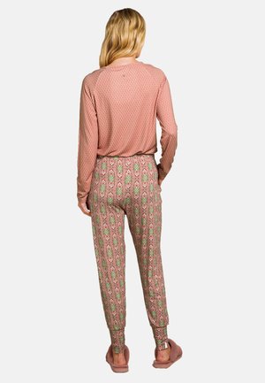 Long-sleeve pink shirt with a geometric pattern, paired with tapered pants featuring a floral design in pink and green hues.