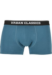 Teal bomullsboxere med svart linning som har "URBAN CLASSICS" i hvit skrift; inkluderer søm detaljer og en funksjonell kile.