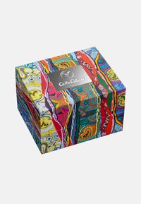 Colorful gift box featuring intricate patterns in red, blue, yellow, and green, with a silver logo plate on the front.