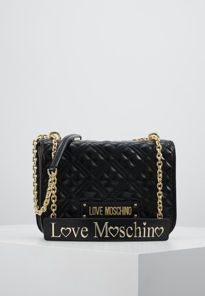 Black quilted handbag with gold chain strap, gold "Love Moschino" logo on the front and on a large decorative tag at the base.