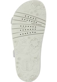 Suela de zapato de goma blanca con patrones florales y en forma de estrella, agujeros de ventilación y la inscripción "SISTEMA FLEXY". Texturizada para agarre.