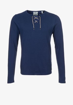 Marineblaues Langarmshirt mit rundem Ausschnitt und beigen Schnürdetails am Hals.
