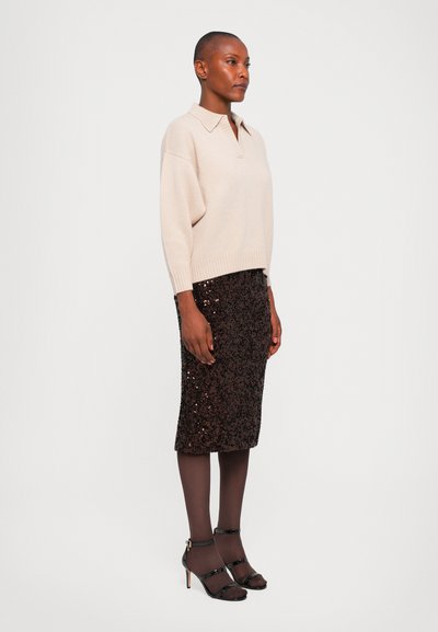 Beige knit sweater with a collar, paired with a fitted sequined brown pencil skirt and black strappy heels, worn with sheer brown tights.