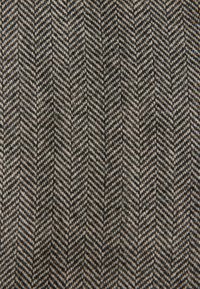 Herringbone woven fabric in gray and black tones, featuring a textured pattern with alternating chevron shapes and subtle highlights.