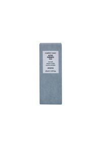 Gray rectangular box for clay mask labeled "ACTIVE PURENESS." Includes product details and volume information. Matte finish, minimalist design.