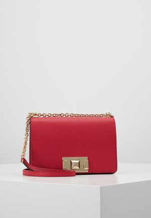 Rode leren schoudertas met gouden kettingband en rechthoekige gouden sluiting, geplaatst op een witte ondergrond tegen een effen achtergrond.