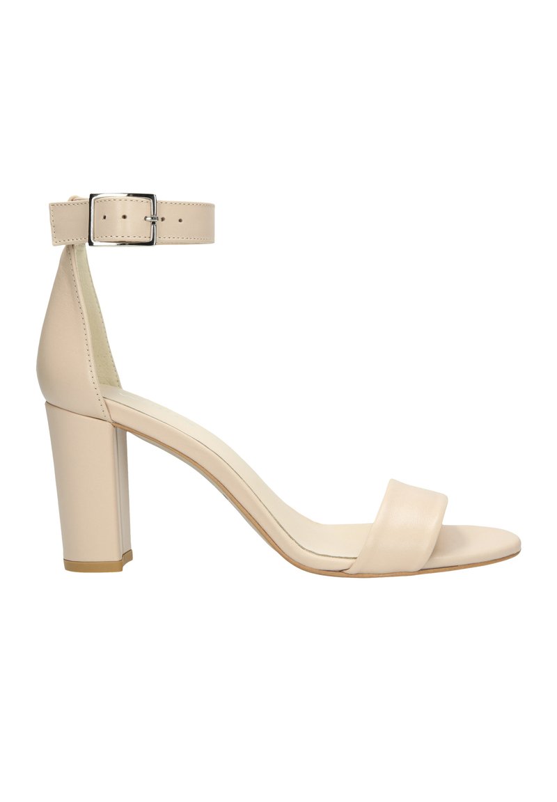 Beige high-heeled sandal with a wide toe strap, a narrow ankle strap with a metal buckle, and a square block heel. Smooth leather finish.