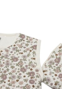 Mouwloze top met bloemmotief in crèmekleurige stof, voorzien van roze, groene en bruine bloemen. Soepele textuur met een ronde halslijn en een zachte afwerking.