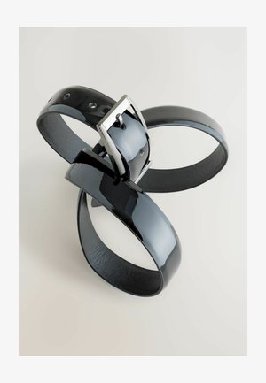 Black patent leather belt featuring a textured silver metal buckle. The belt loops are smooth, with visible adjustment holes.