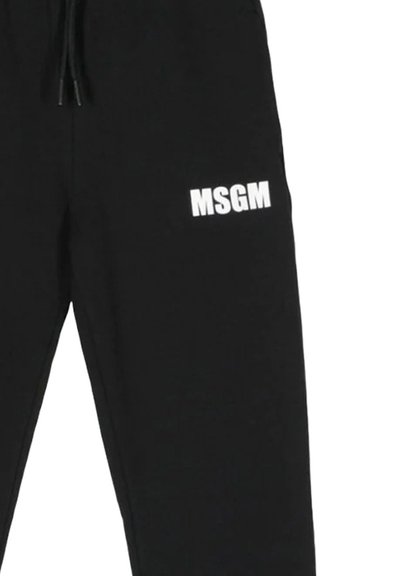Pantaloni da jogging neri dal fit rilassato, con il logo bianco "MSGM" stampato sulla parte bassa della gamba sinistra e una cintura regolabile con cordino.