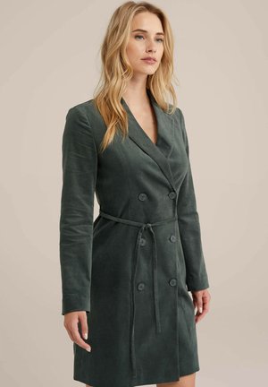 Dark green double-breasted coat made of soft fabric, featuring a tie waist, long sleeves, and notched lapels; smooth texture.