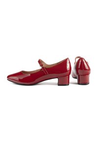 Red patent leather Mary Jane shoes with a low block heel, rounded toe, and adjustable strap with a buckle detail. Smooth glossy finish.