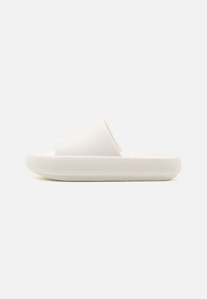 White slide sandal featuring a textured strap and a rounded, elevated sole. The material appears smooth and durable with a subtle pattern.